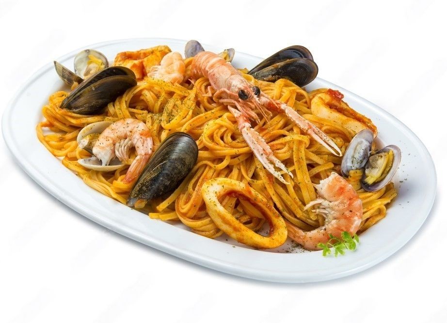 Plate of seafood pasta with shrimp, mussels, and squid in a marinara sauce.